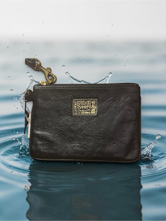 Coach Handbags - Coach poppy Black Leather Wristlet with Gold Logo Patch